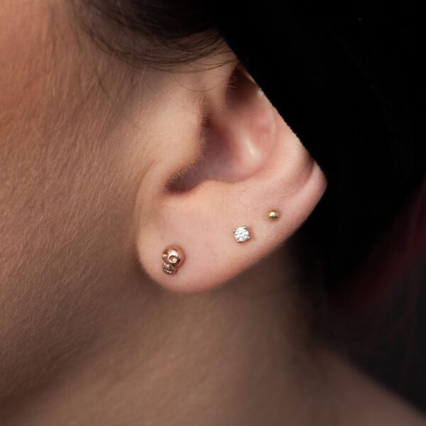 diamond stud and mini rose gold skull earrings