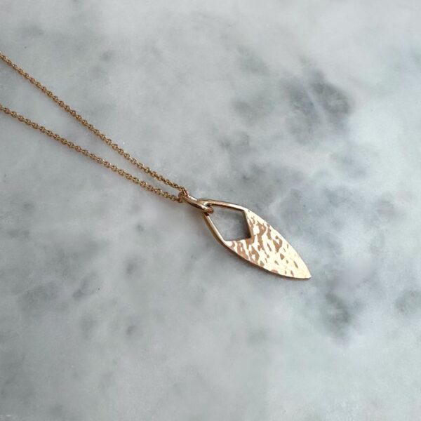 Artefact pendant in yellow gold with hammer tone finish