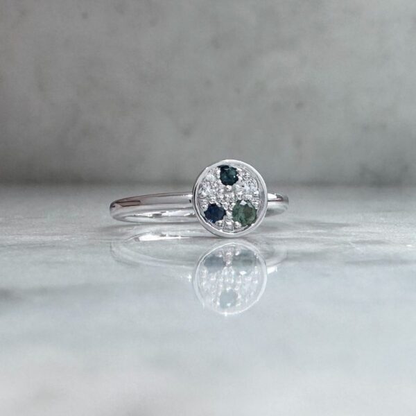 Petite galaxy ring in 9ct white gold with a galaxy of bead set gemstones featuring sapphires, tourmaline and diamonds.