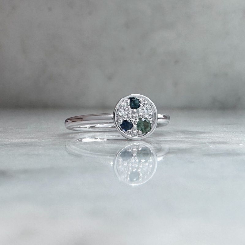 Petite galaxy ring in 9ct white gold with a galaxy of bead set gemstones featuring sapphires, tourmaline and diamonds.