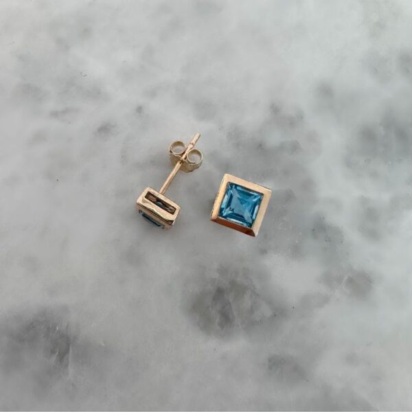 princess cut topaz stud earrings in yellow gold