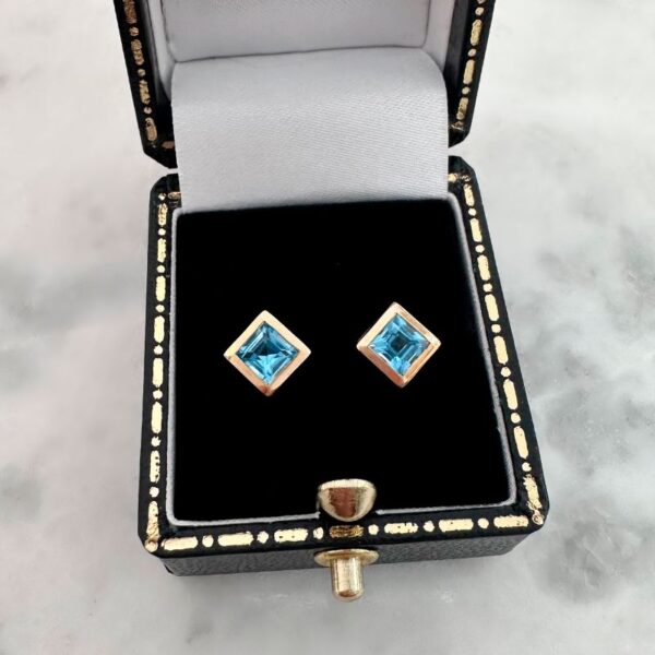 princess cut topaz stud earrings in yellow gold