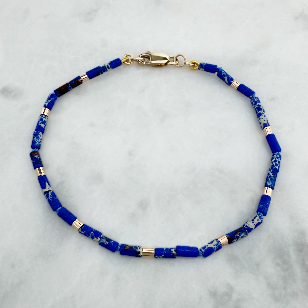 juju gems jewellery artefact bracelet featuring blue imperial jasper and yellow gold