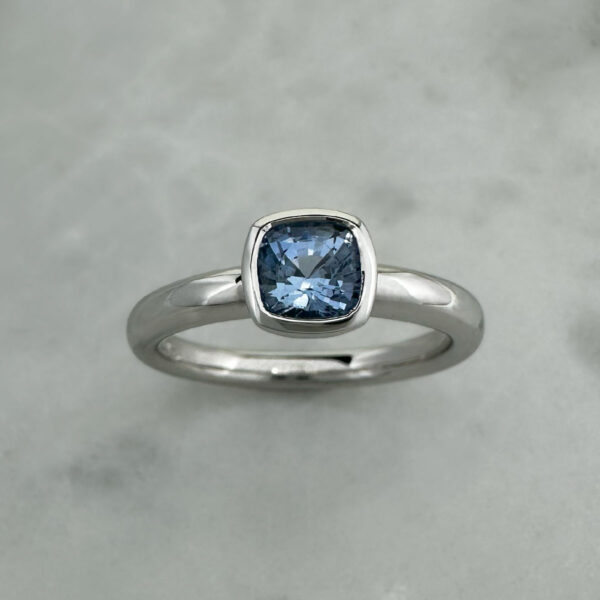 white gold solitaire ring with a blue sapphire